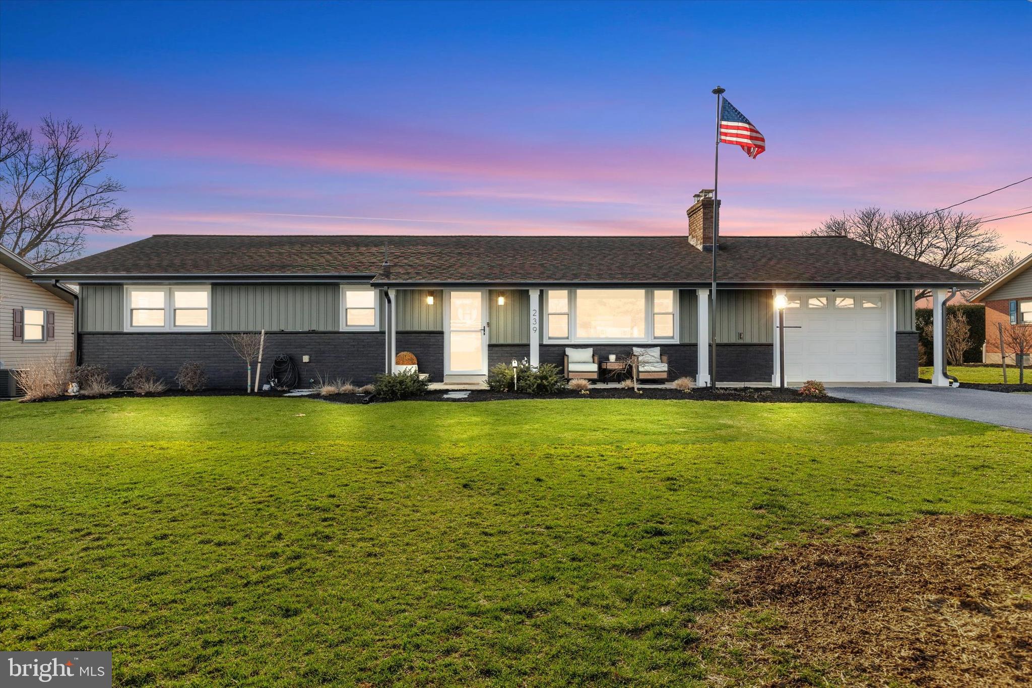 a front view of a house with a garden