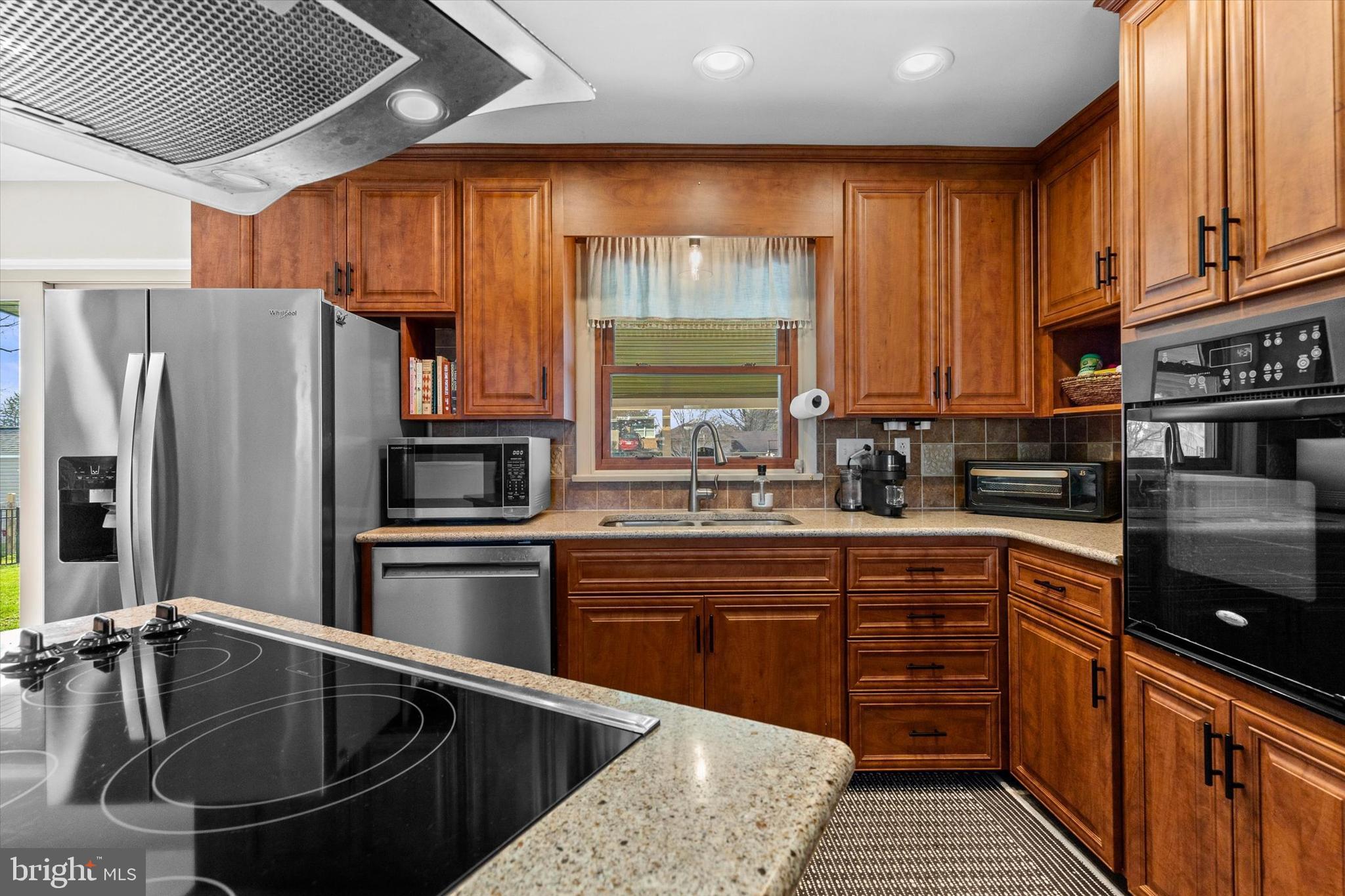 239 Mill Road Mount Joy, PA 17552 - Photo 11 of 42 a kitchen with granite countertop a sink stainless steel appliances and cabinets