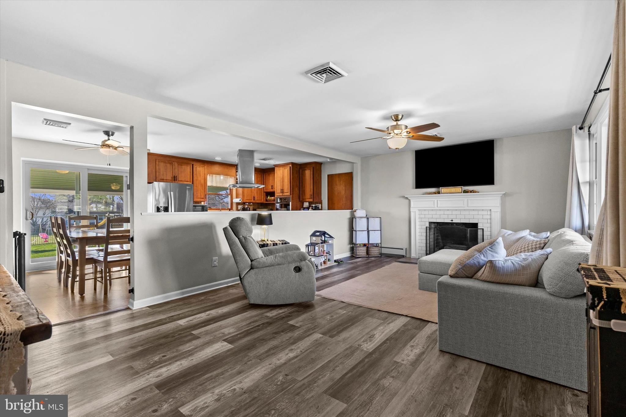 239 Mill Road Mount Joy, PA 17552 - Photo 5 of 42 a living room with furniture a fireplace and a flat screen tv