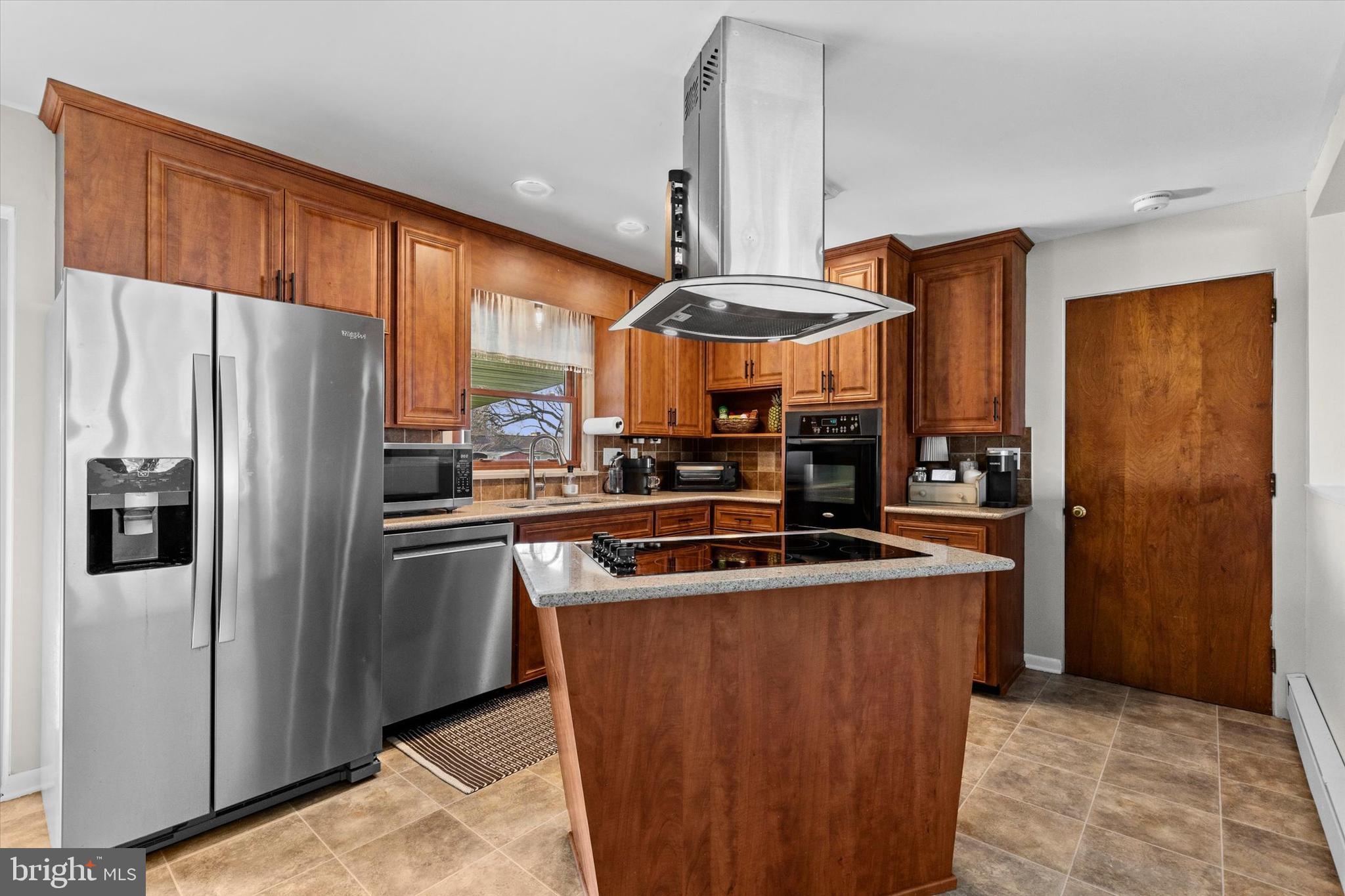 239 Mill Road Mount Joy, PA 17552 - Photo 10 of 42 a kitchen with stainless steel appliances granite countertop a refrigerator a sink and a stove