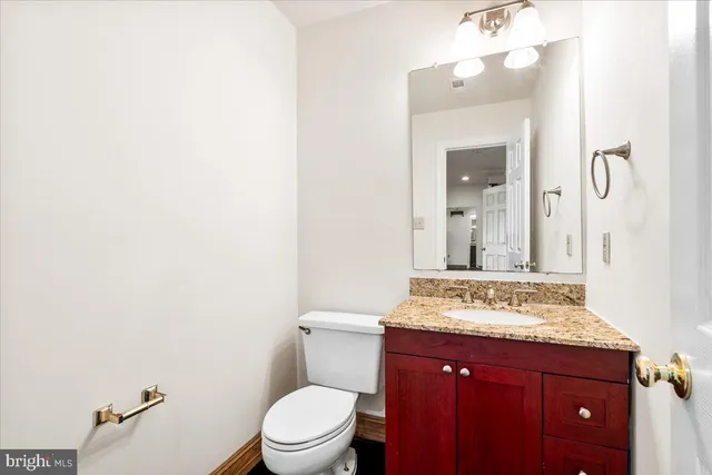 a bathroom with a sink a toilet and mirror