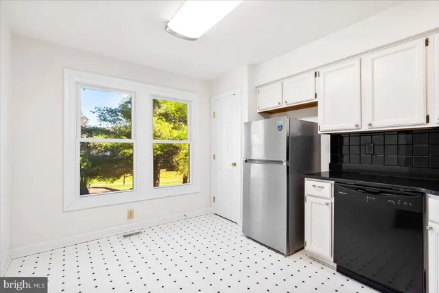 a kitchen with stainless steel appliances a refrigerator and a stove top oven