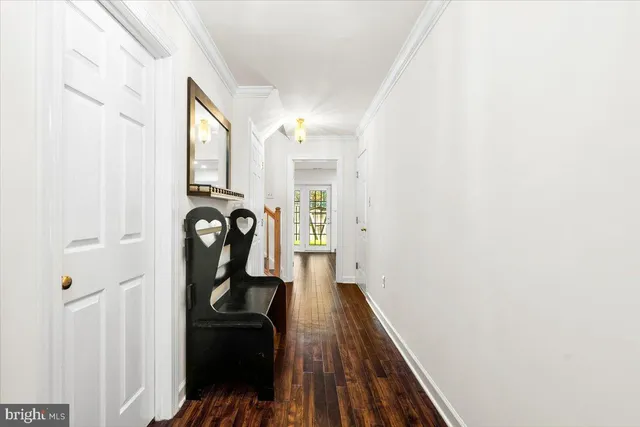 a view of a hallway with wooden floor and entryway