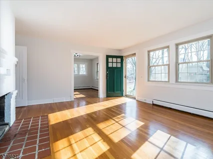 a view of a livingroom with wooden floor and a rug