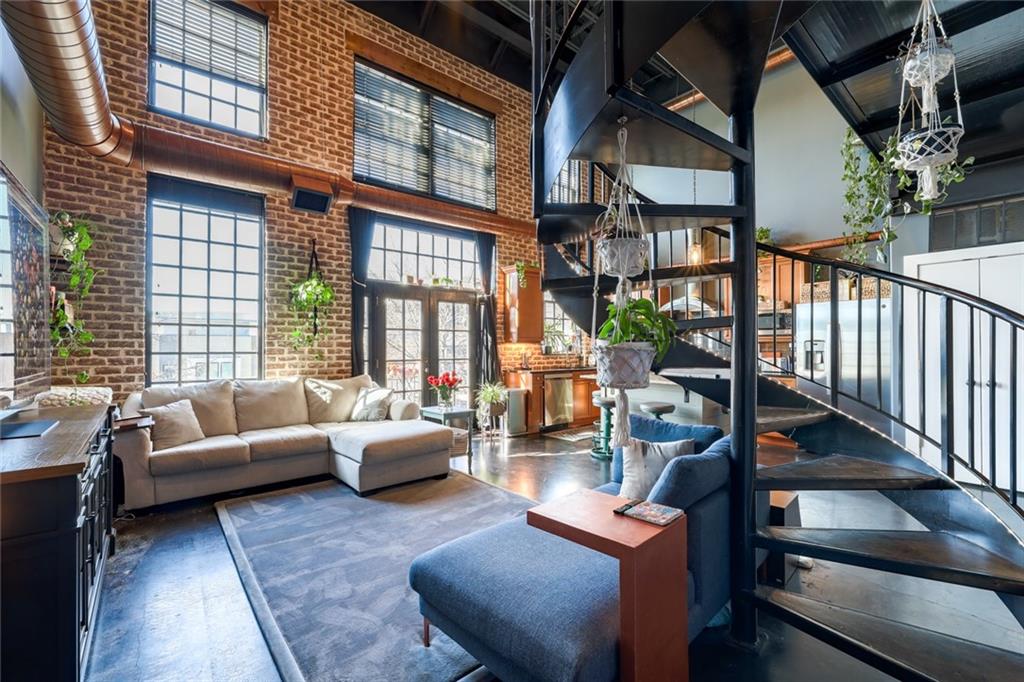 a living room with furniture fireplace and a large window
