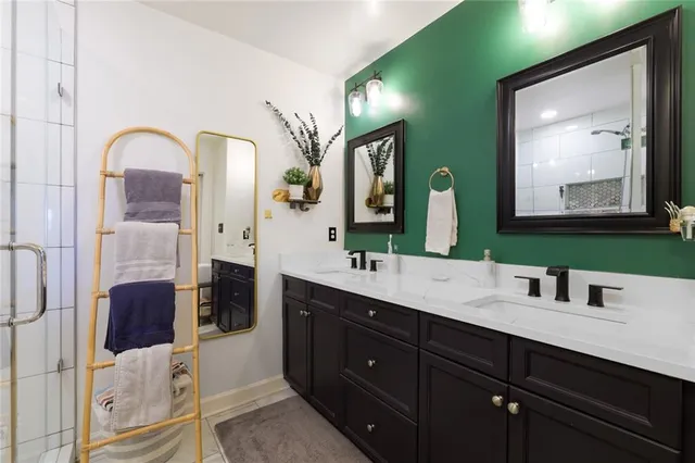 a bathroom with a double vanity sink and mirror
