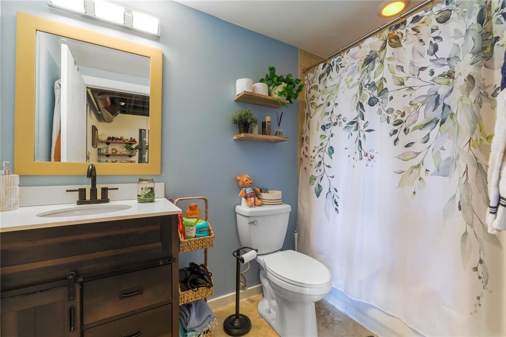 5434 Peachtree Road, Unit 109 Atlanta, GA 30341 - Photo 15 of 32 a bathroom with a sink toilet vanity and mirror