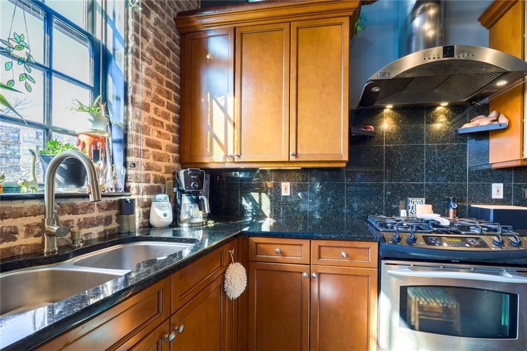 5434 Peachtree Road, Unit 109 Atlanta, GA 30341 - Photo 5 of 32 a kitchen with a sink and cabinets