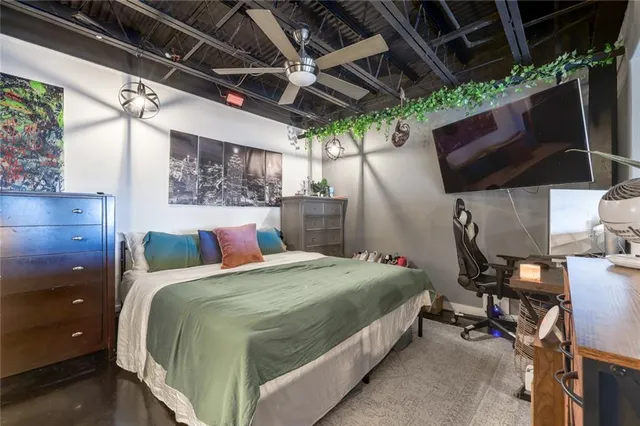 a bed room with a bed and a television