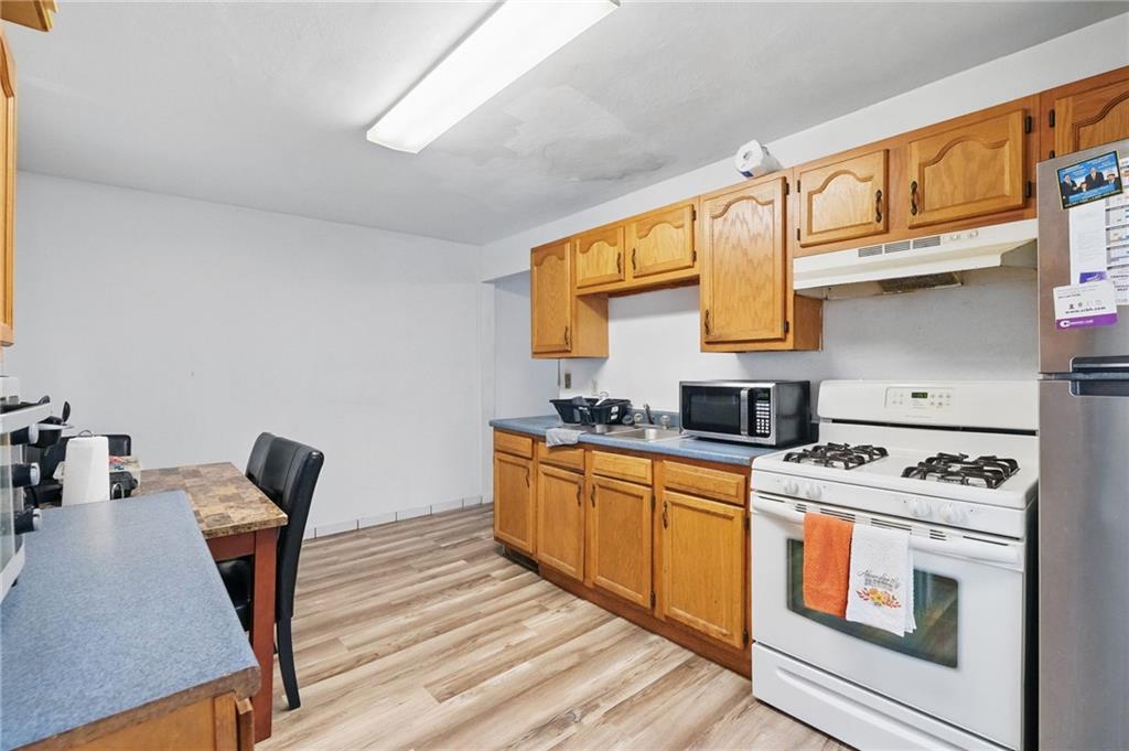 26 May Avenue McKees Rocks, PA 15136 - Photo 12 of 28 a kitchen with stainless steel appliances granite countertop a stove a sink and a microwave
