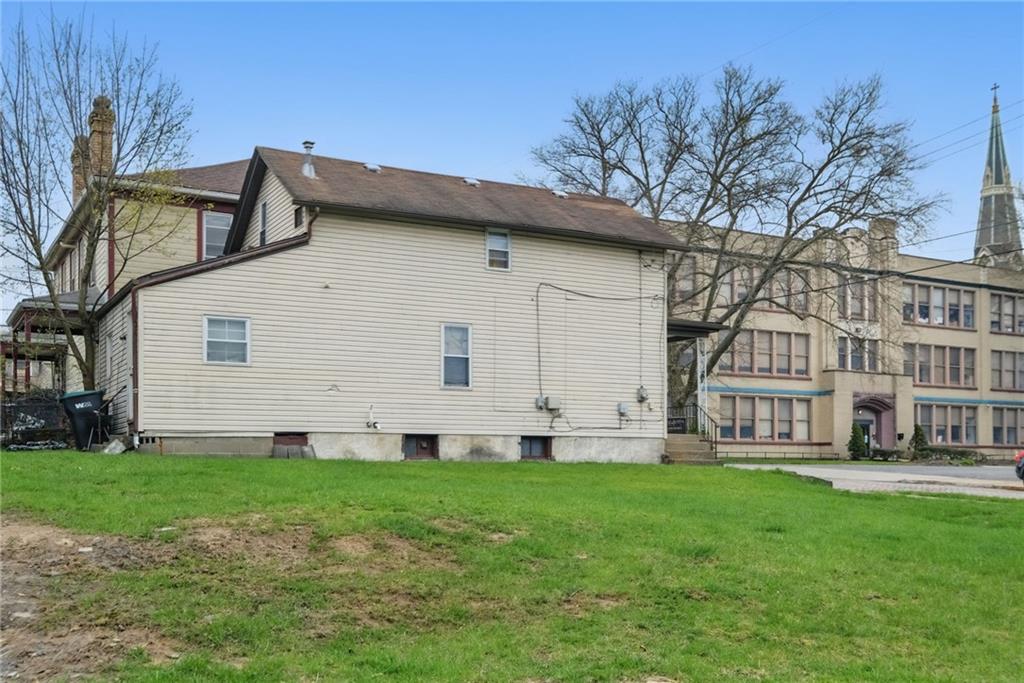 26 May Avenue McKees Rocks, PA 15136 - Photo 21 of 28 a large white house with a white door in front of a yard