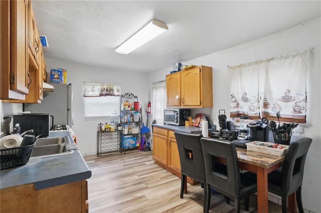 26 May Avenue McKees Rocks, PA 15136 - Photo 10 of 28 a kitchen with a table chairs stove and refrigerator