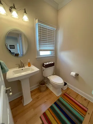 a bathroom with a sink mirror and toilet