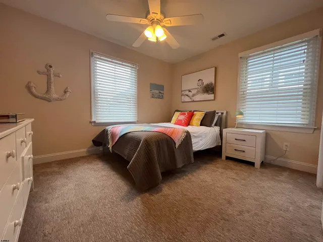 a bathroom with a granite countertop sink a toilet and a shower curtain