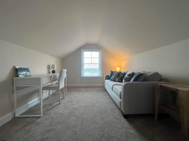 a bedroom with two bed and a window