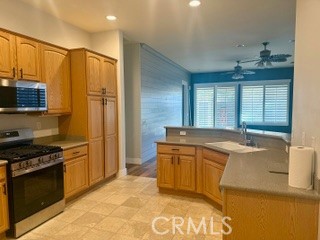 10495 Bridge Haven Road Apple Valley, CA 92308 - Photo 3 of 19 a kitchen with stainless steel appliances granite countertop a sink stove and refrigerator