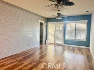 10495 Bridge Haven Road Apple Valley, CA 92308 - Photo 6 of 19 a view of an empty room with a window and wooden floor