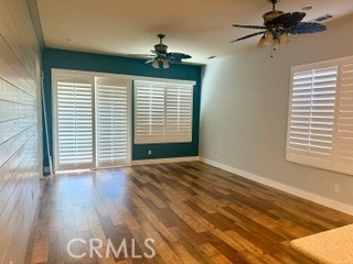 10495 Bridge Haven Road Apple Valley, CA 92308 - Photo 7 of 19 a view of an empty room with a window and wooden floor