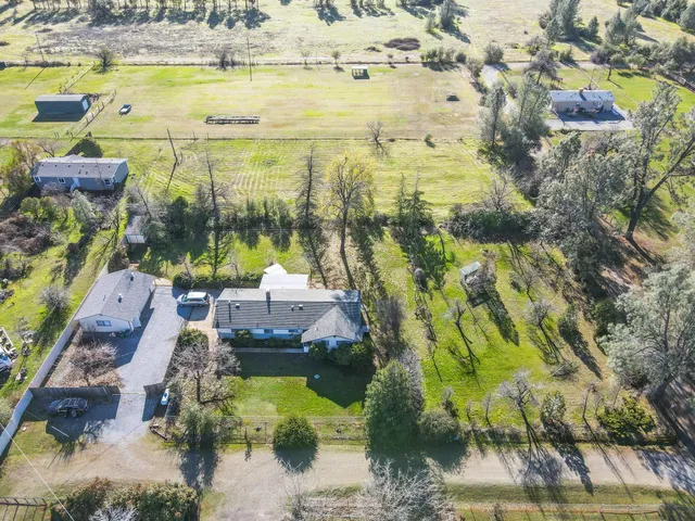a view of empty room with wooden floor and fireplace