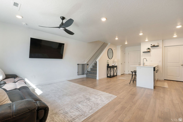 1693 Devils Gdn Lane Washington, UT 84780 - Photo 6 of 64 Open-concept living area with wood-finish flooring, a modern ceiling fan, and recessed lighting