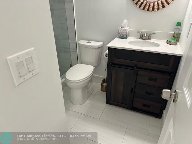 7605 Northwest 5th Court, Unit 208 Margate, FL 33063 - Photo 15 of 25 a bathroom with a sink toilet and vanity