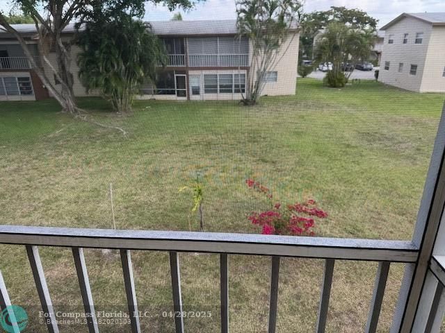 7605 Northwest 5th Court, Unit 208 Margate, FL 33063 - Photo 19 of 25 a view of a porch with a yard