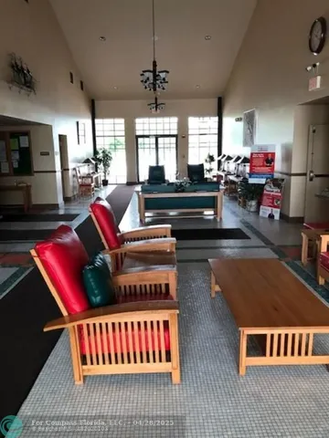 a living room with lots of furniture and a book shelf