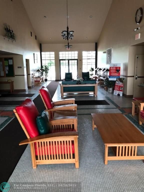 7605 Northwest 5th Court, Unit 208 Margate, FL 33063 - Photo 25 of 25 a living room with lots of furniture and a book shelf