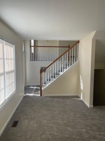 wooden floor in a hall with a window