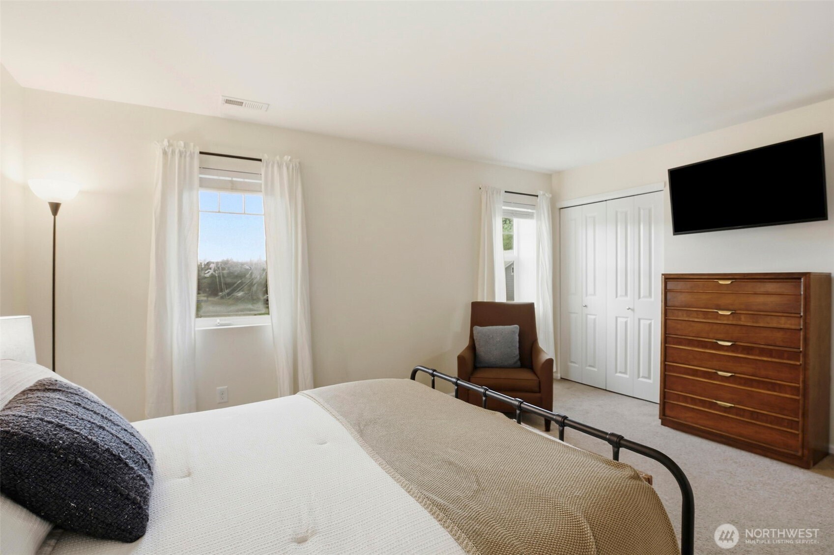 3662 London Loop Northeast Lacey, WA 98516 - Photo 22 of 40 a bedroom with a bed and television