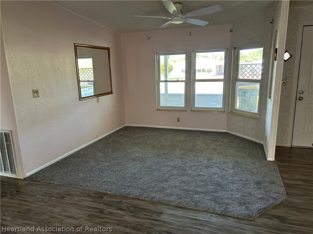 337 Hickory Ridge Drive Sebring, FL 33876 - Photo 20 of 48 an empty room with wooden floor and windows
