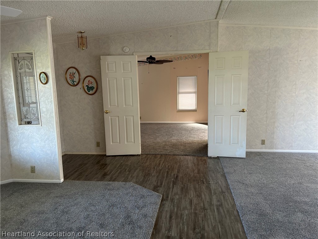 337 Hickory Ridge Drive Sebring, FL 33876 - Photo 21 of 48 an empty room with wooden floor and mirror