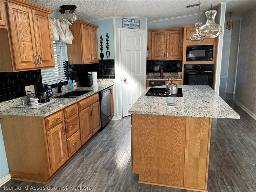 337 Hickory Ridge Drive Sebring, FL 33876 - Photo 23 of 48 a kitchen with stainless steel appliances granite countertop a stove a sink dishwasher and a refrigerator