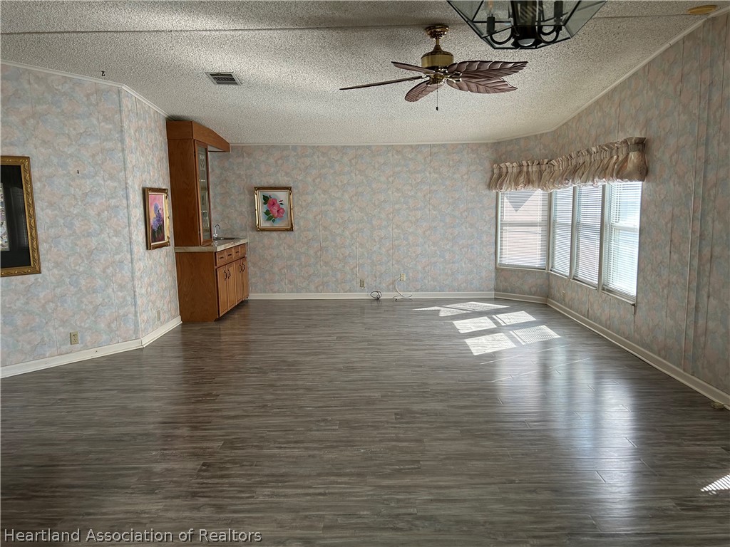 337 Hickory Ridge Drive Sebring, FL 33876 - Photo 25 of 48 a view of empty room with wooden floor and fan