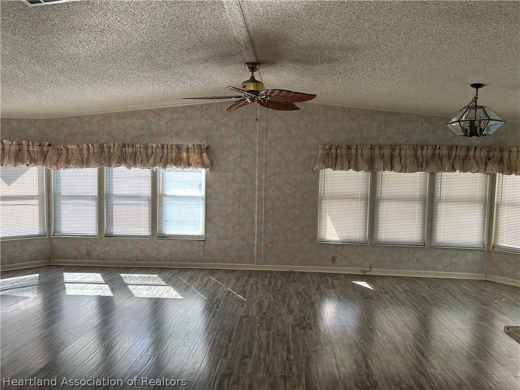 337 Hickory Ridge Drive Sebring, FL 33876 - Photo 28 of 48 a view of an empty room with wooden floor and a window