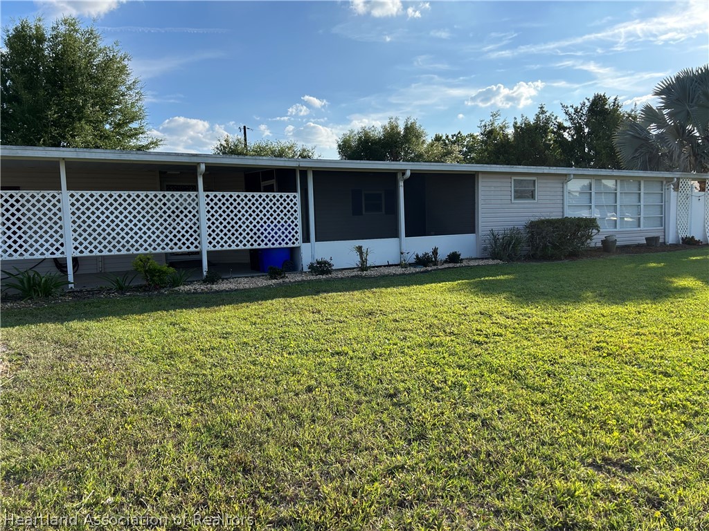 337 Hickory Ridge Drive Sebring, FL 33876 - Photo 37 of 48 a view of a large pool with a big yard and potted plants