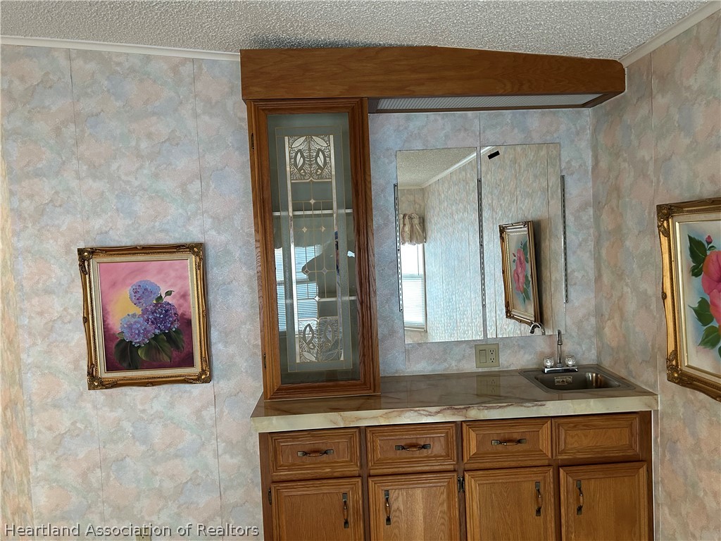 337 Hickory Ridge Drive Sebring, FL 33876 - Photo 42 of 48 a bathroom with a granite countertop sink a mirror and a