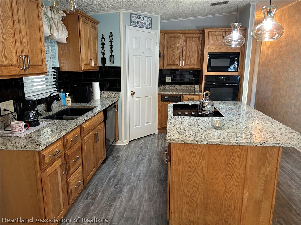 337 Hickory Ridge Drive Sebring, FL 33876 - Photo 45 of 48 a kitchen with granite countertop a sink a stove and cabinets
