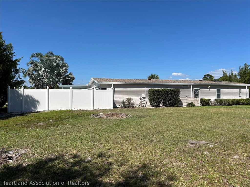 337 Hickory Ridge Drive Sebring, FL 33876 - Photo 6 of 48 a front view of a house with a garden and yard