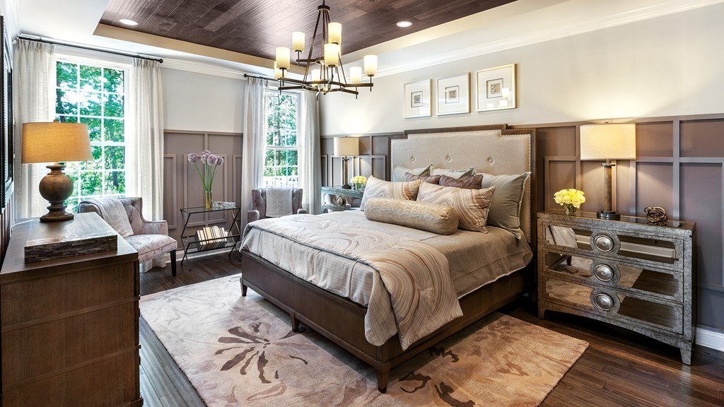 a bedroom with a bed a dresser next to a window