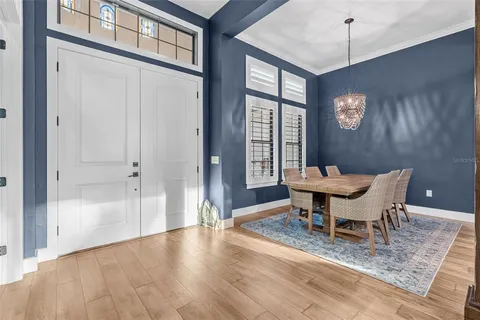 a view of a dining room with furniture window and wooden floor