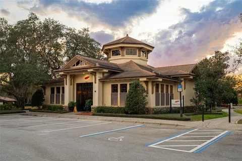 an aerial view of a house with swimming pool and mountains