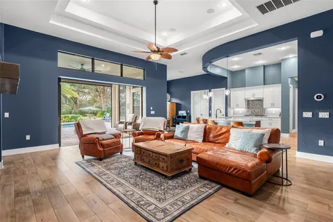 a living room with furniture ceiling fan and a rug