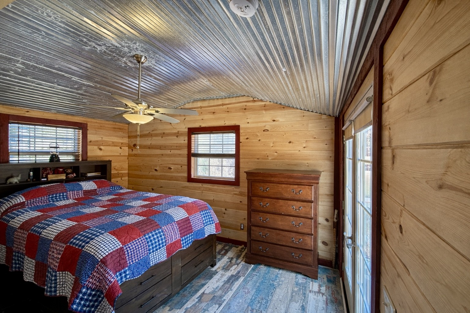 664 Russ Valley Road Lobelville, TN 37097 - Photo 29 of 57 a bedroom with a bed and a dresser next to a window