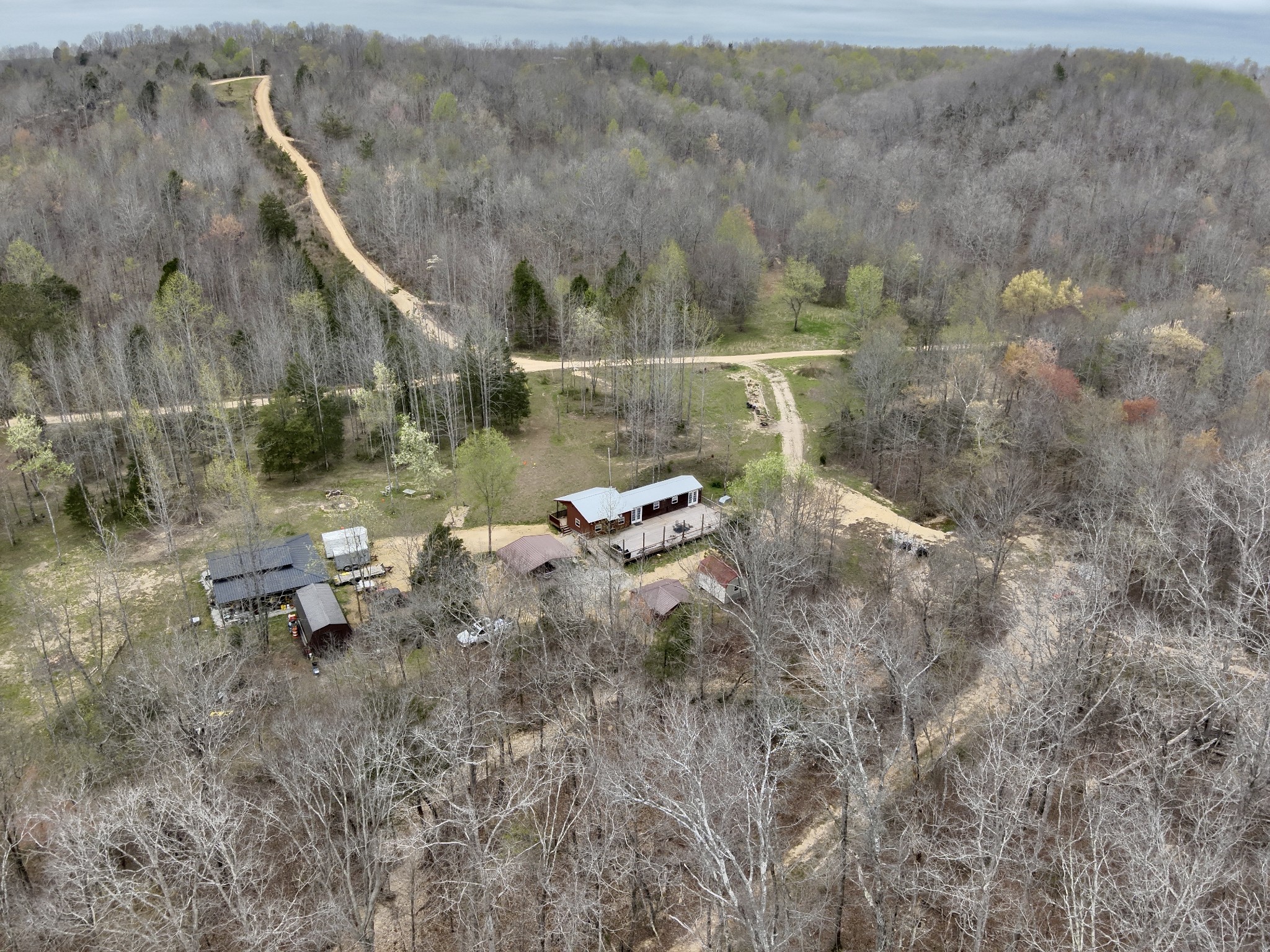 664 Russ Valley Road Lobelville, TN 37097 - Photo 3 of 57 a backyard of a house with table and chairs