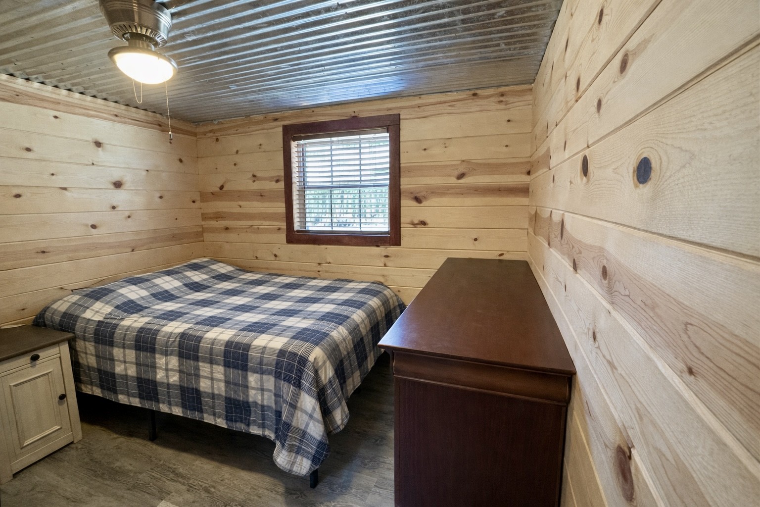 664 Russ Valley Road Lobelville, TN 37097 - Photo 32 of 57 a bedroom with a bed and a window