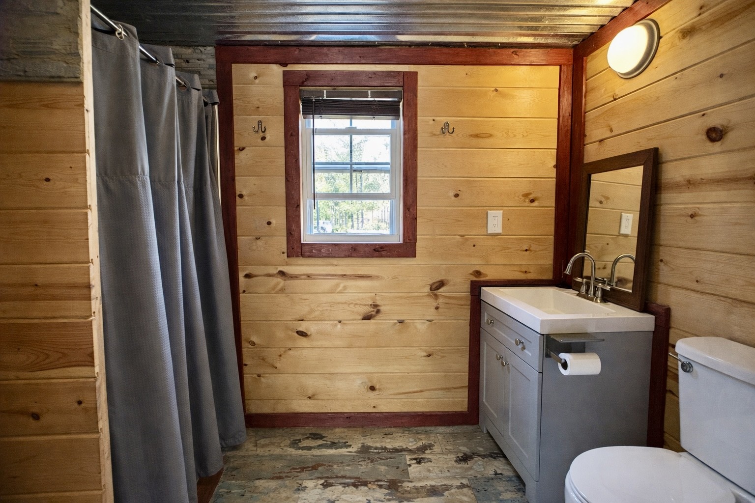 664 Russ Valley Road Lobelville, TN 37097 - Photo 38 of 57 a bathroom with a sink toilet and shower