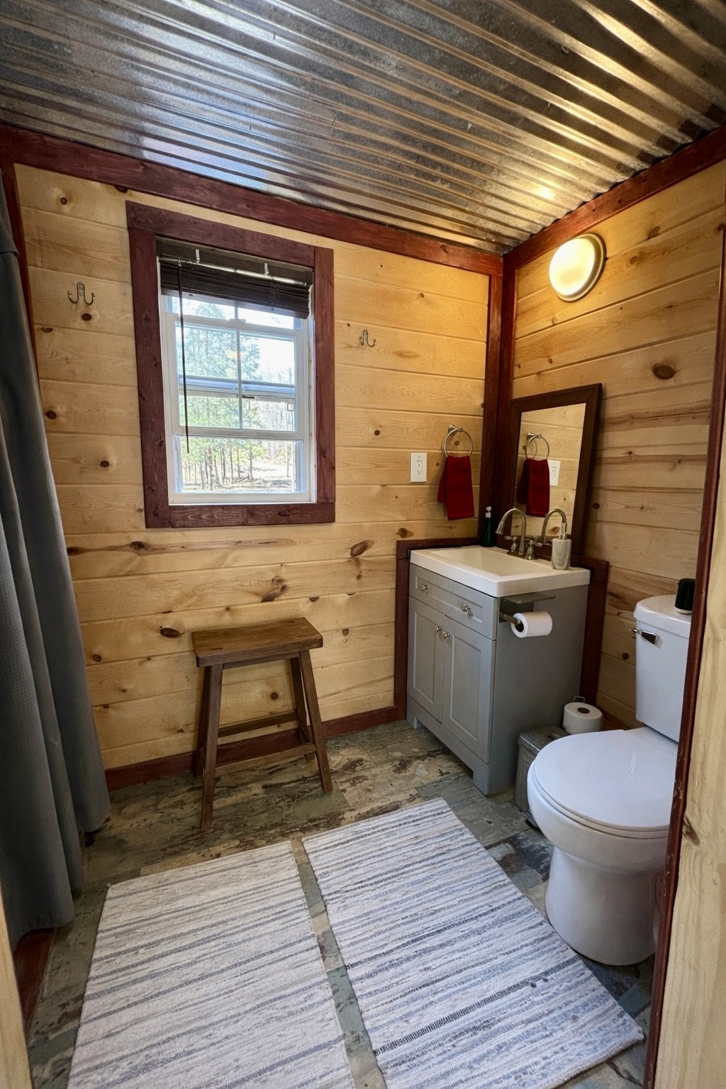 664 Russ Valley Road Lobelville, TN 37097 - Photo 39 of 57 a bathroom with a sink a toilet and a window