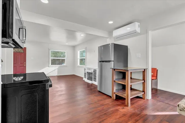 a kitchen with kitchen island white cabinets and stainless steel appliances