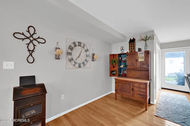 a view of a workspace with furniture and wooden floor